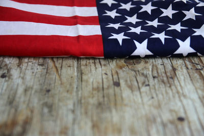 Close-up of american flag on wooden table