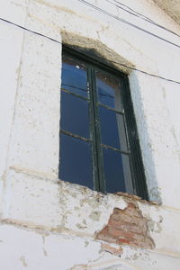 Low angle view of window on old building