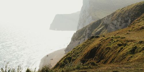 High angle view of coastline by mountains