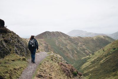 Rear view of woman hiking on mountain