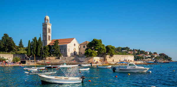 Boats in sea against buildings