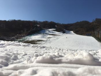 Tire tracks on snow covered landscape