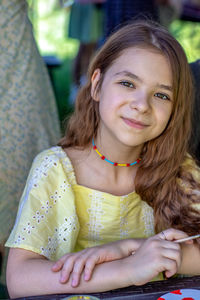 Portrait of smiling young woman sitting at home