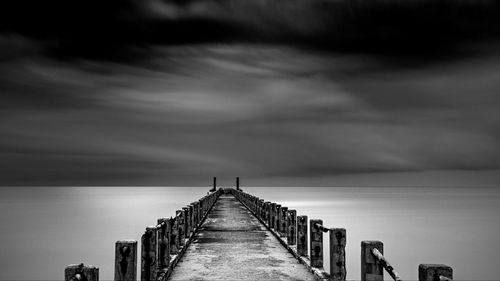 Pier over sea against sky