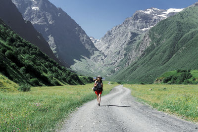 Rear view of man riding on mountain road