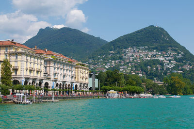 Beautiful view of some old buildings of lugano switzerland seen from the lake on summer