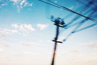 Low angle view of power lines against blue sky