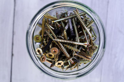 Directly above shot of screws in jar on table