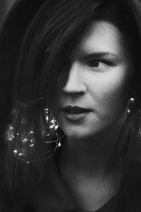 Close up woman with glowing fairy lights monochrome portrait picture