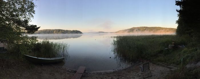 Scenic view of lake against sky at sunset