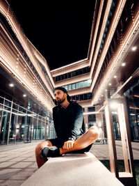 Full length portrait of young man sitting