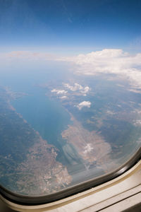 Aerial view of landscape seen through airplane window