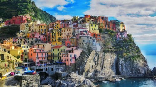 Multi colored houses at cinque terre against sky