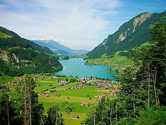 mountain, water, tranquil scene, mountain range, scenics, tranquility, beauty in nature, sea, sky, tree, nature, landscape, high angle view, lake, green color, idyllic, coastline, growth, hill, blue