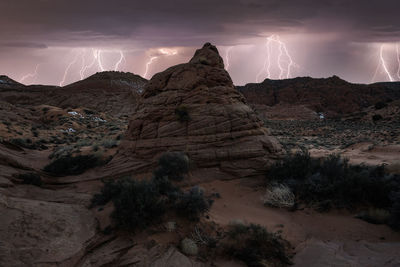 Breathtaking scenery of rocky formations in highlands under under thunderstorm sky with clouds and lightnings in vermillion cliffs national monument, arizona in usa