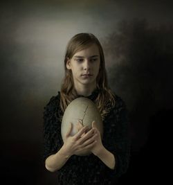 Portrait of woman playing with ball on field