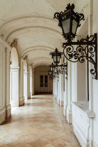 Gas lights in empty corridor of building