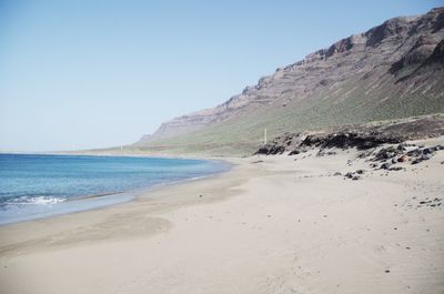 Scenic view of beach against clear sky