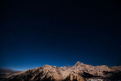 Low angle view of mountain against blue sky