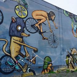 Graffiti on bicycle against wall