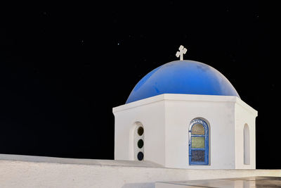 Low angle view of white building against sky at night