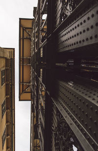 Directly below shot of buildings against clear sky 