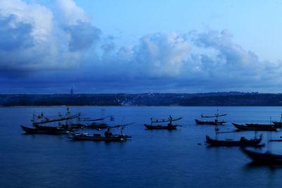 Boats moored in sea against sky