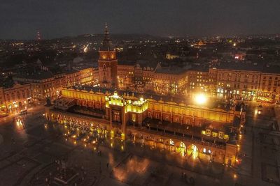 High angle view of illuminated cityscape against sky at night