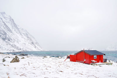 Lifeguard hut on beach against sky