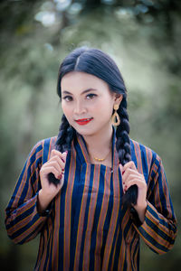 Portrait of young woman standing outdoors