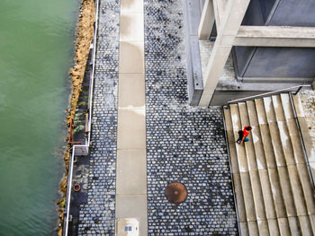 High angle view of woman moving up on steps