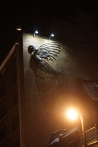 Low angle view of illuminated street light at night