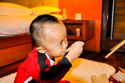 Close-up of boy eating at table