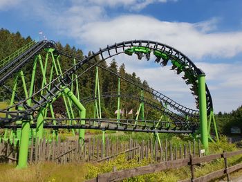 Low angle view of rollercoaster against sky