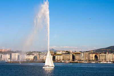 Sailboat sailing in sea against blue sky