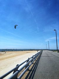 Road leading towards blue sky