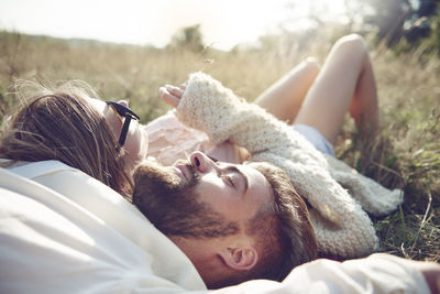 Happy young couple lying in grass