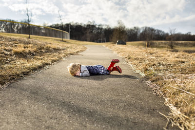 Toddler boy having a tantrum on walking path