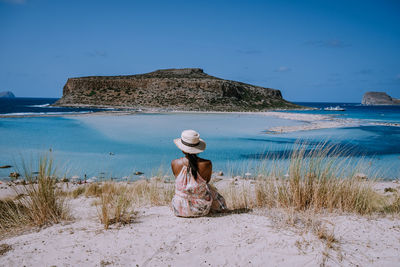 Rear view of woman looking at sea shore