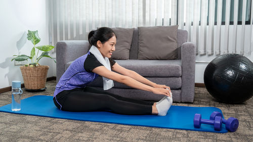 Young woman exercising in gym