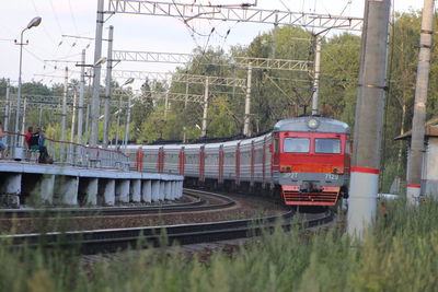 Train by railroad tracks against sky