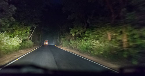 Empty road along trees