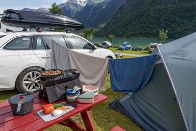 Table with food and stove in front of tent