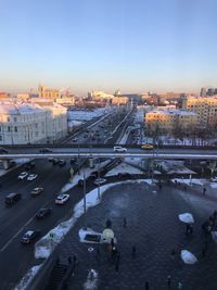 High angle view of cityscape by river against sky