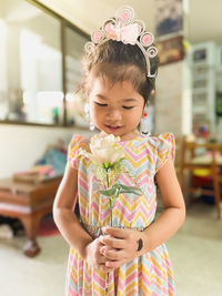 Portrait of a girl standing against the wall