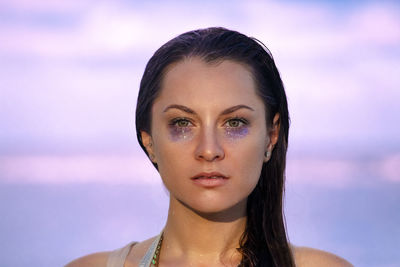 Portrait of young woman against sky during sunset