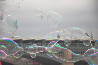 Low angle view of bubbles against sky