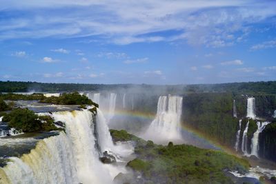 Scenic view of waterfall against sky