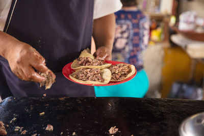 Midsection of man preparing food in kitchen