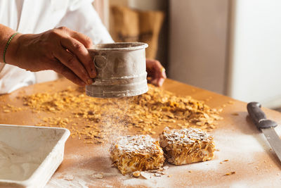 Midsection of person preparing food on table